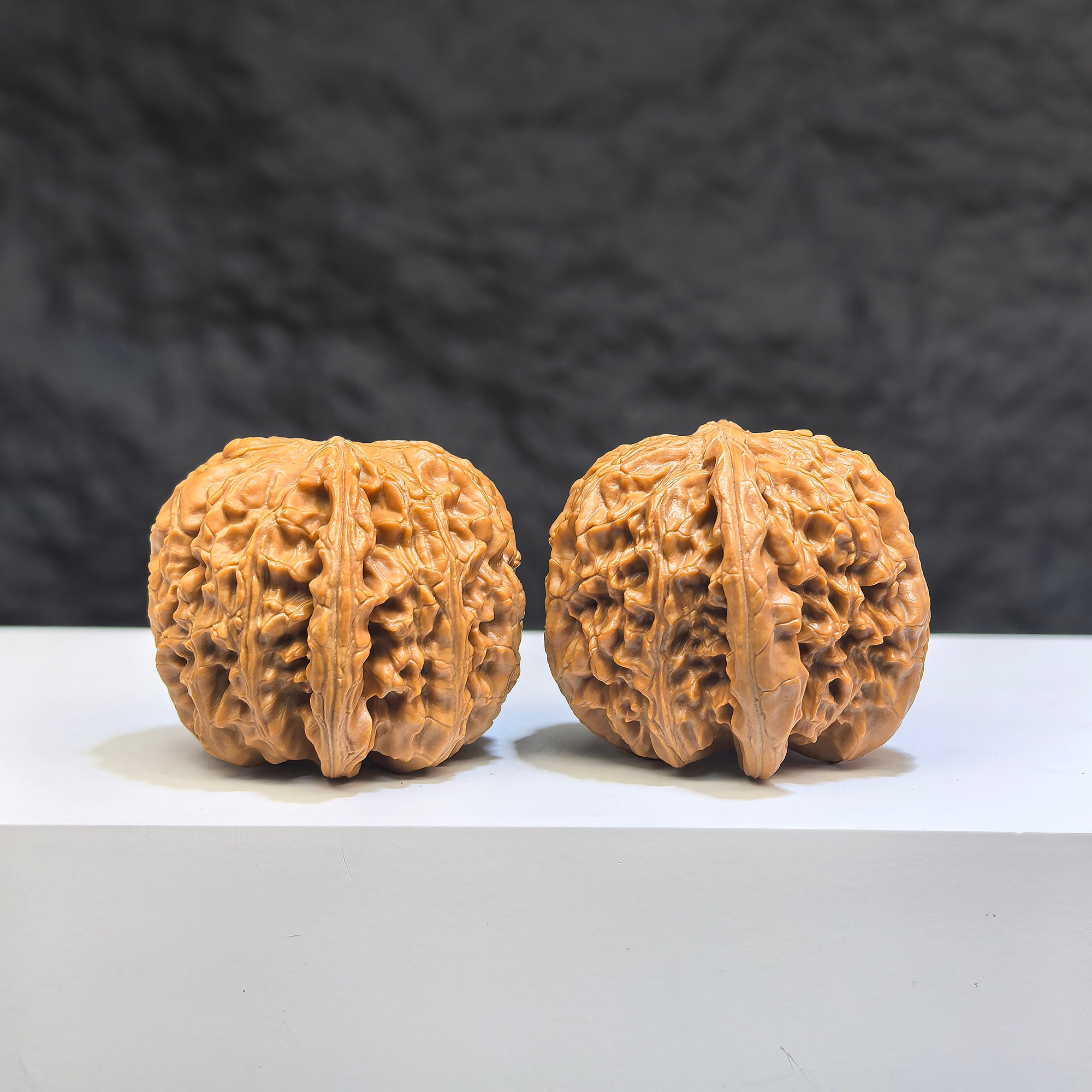 Miniature Wenwan Walnut pair featuring white lion carvings, crafted by Wenwan Art, measuring 32x34mm in size.