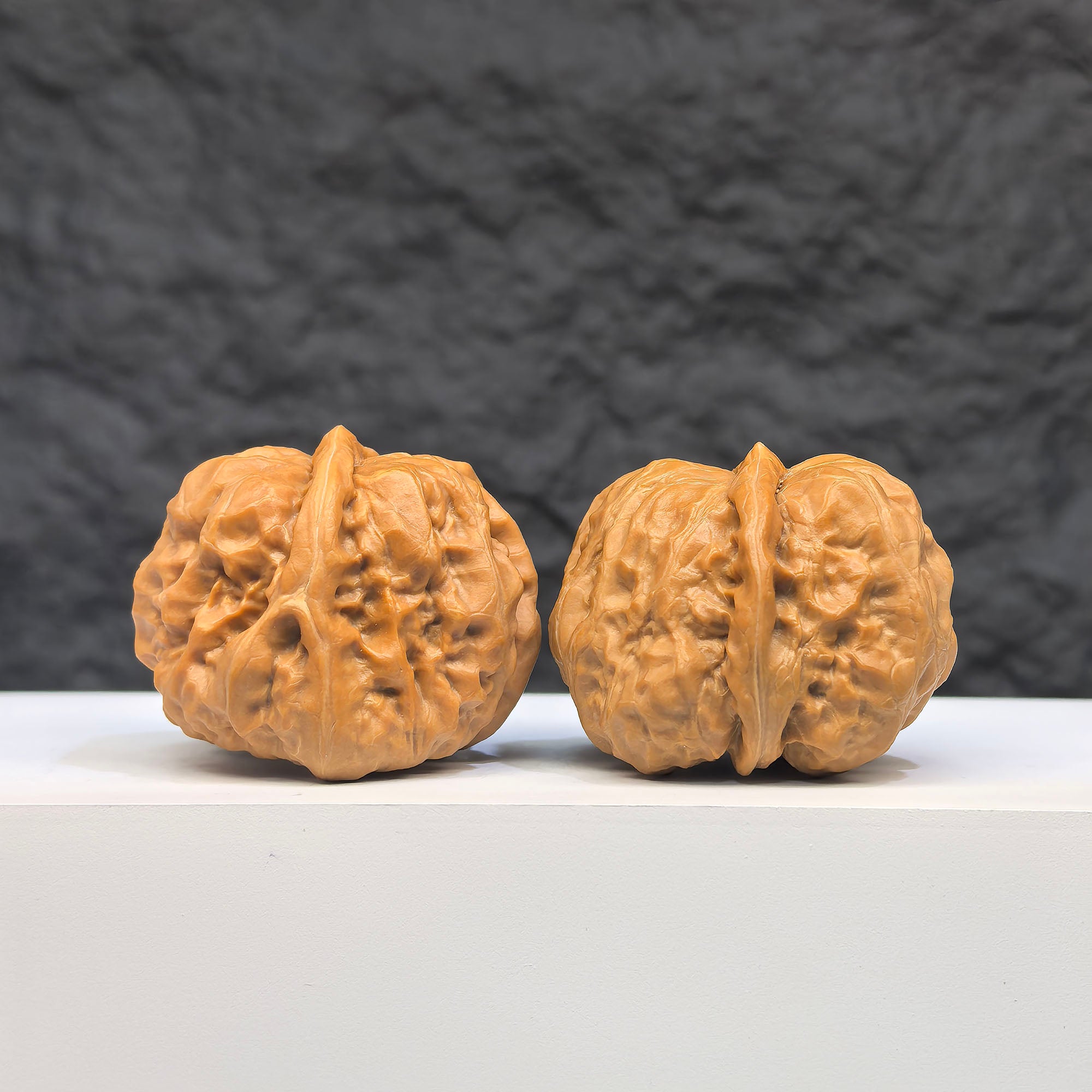 Pair of "Toad Head" Wenwan walnuts from Wenwan Art, featuring detailed carvings, 37mm x 35mm, showcasing traditional craftsmanship.