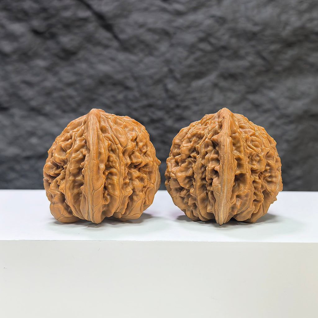 Pair of Sizuolou Wenwan walnuts by Wenwan Art, 42mm x 41mm, showcasing detailed natural walnut carvings and smooth polished surfaces.