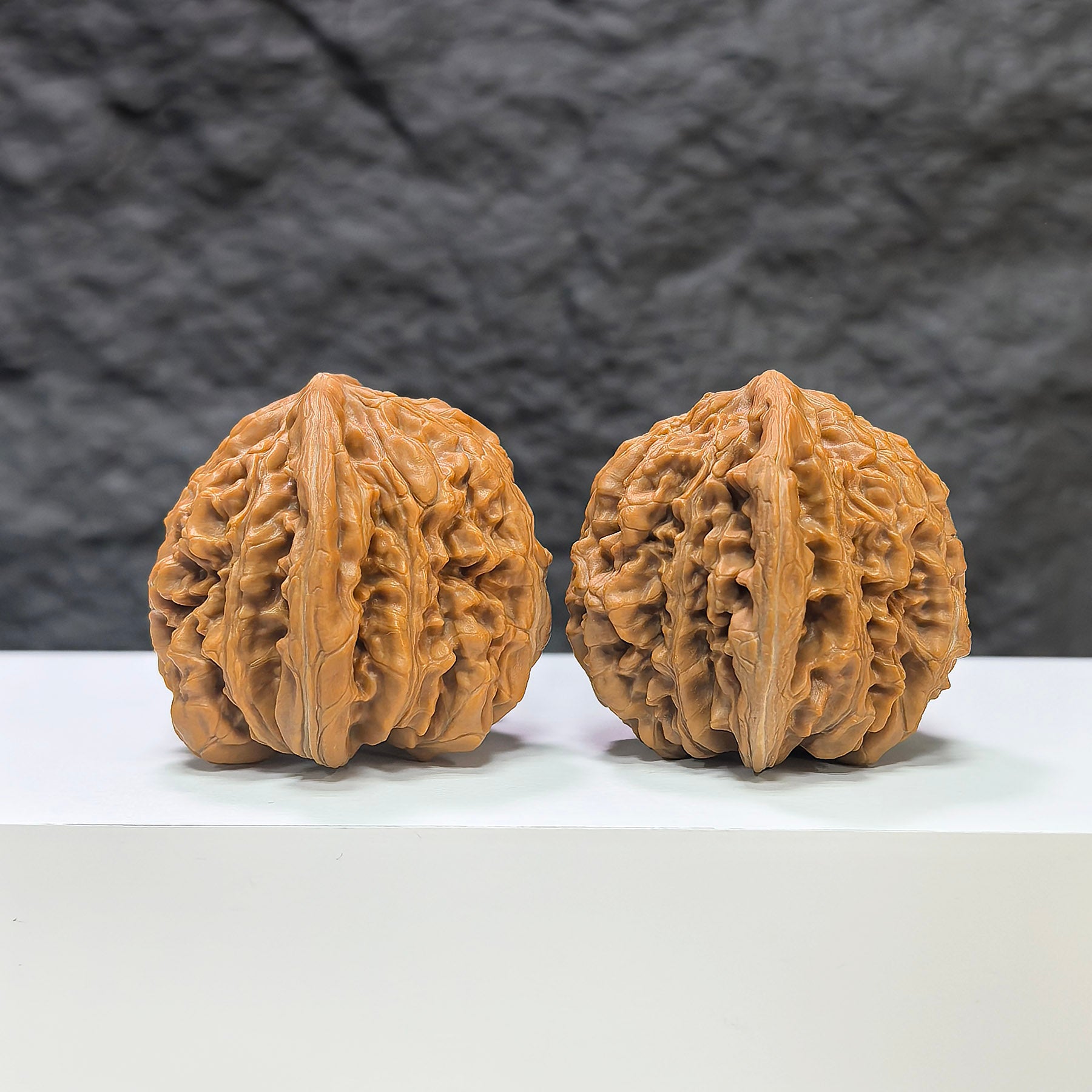 Pair of Sizuolou Wenwan walnuts by Wenwan Art, 42mm x 41mm, showcasing detailed natural walnut carvings and smooth polished surfaces.