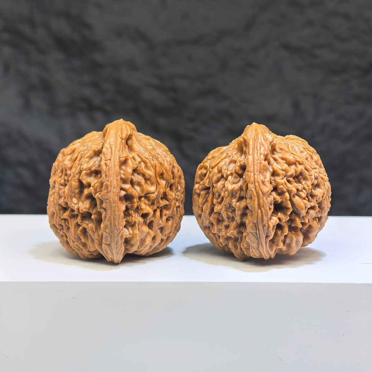 Pair of Nanjiangstone Wenwan walnuts by Wenwan Art, 37mm each, showcasing smooth, polished natural stone with intricate patterns.