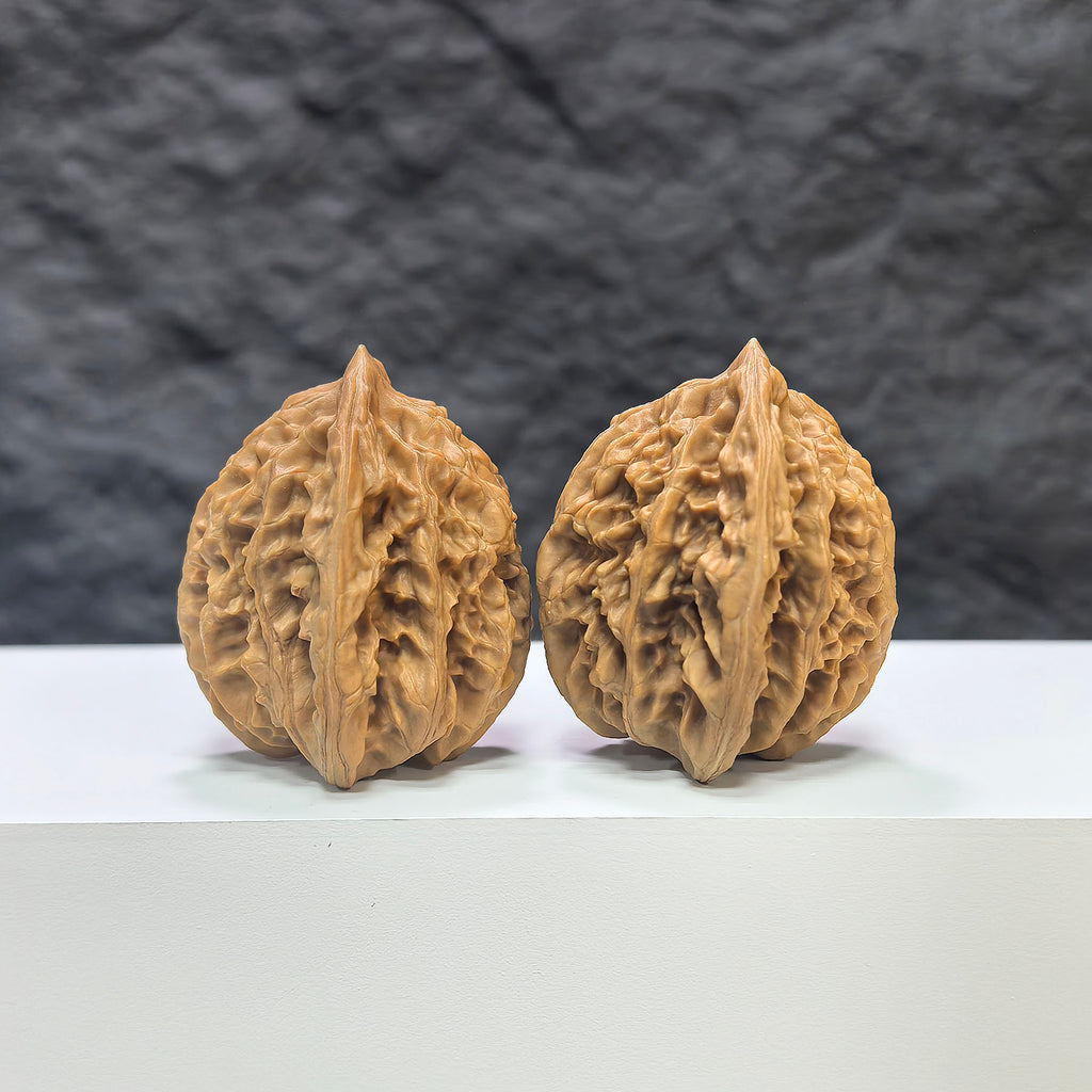 Pair of Xiayunling Classic Wenwan walnuts from Wenwan Art, 37mm x 35mm, featuring detailed carved surface.