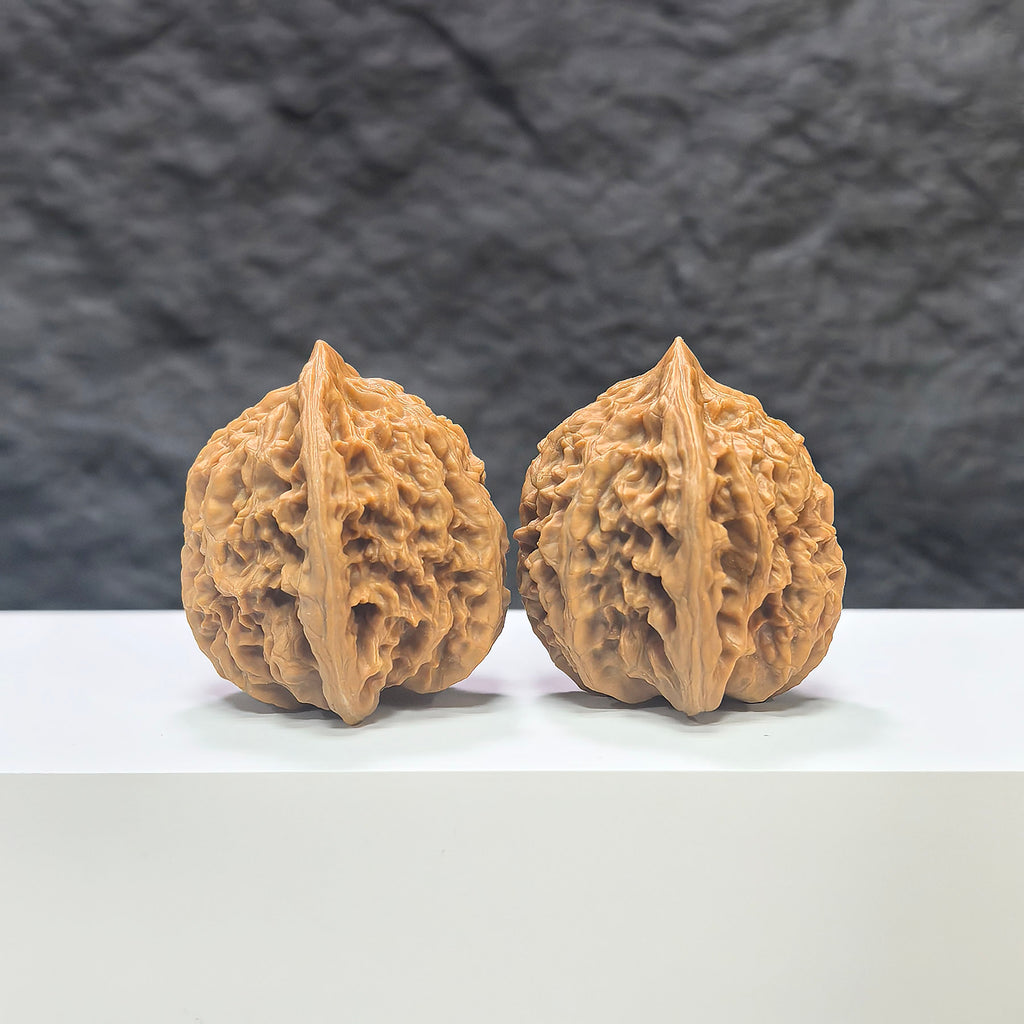 Pair of Peach Heart Xiayunling Wenwan walnuts from Wenwan Art, showing smooth, polished surface with natural wood grain patterns.