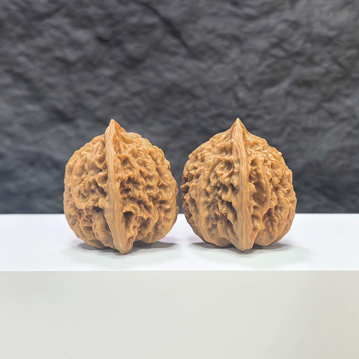 Pair of Peach Heart Xiayunling Wenwan walnuts from Wenwan Art, showing smooth, polished surface with natural wood grain patterns.