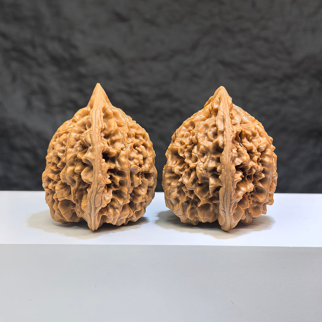 Hand-matched Wenwan Scholar walnuts by Wenwan Art, featuring peach-heart carved design, 47mm x 43mm, with qilin pattern.