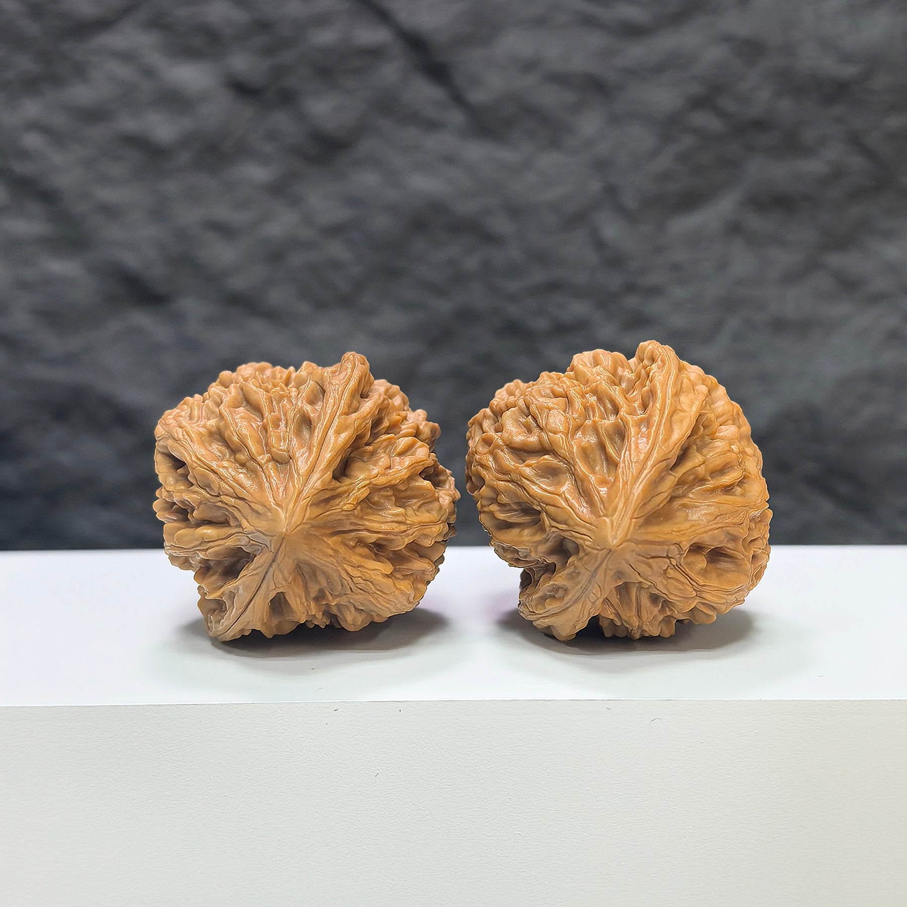 Pair of Beijing Chicken Heart Wenwan walnuts from Wenwan Art, 37-38mm, showcasing smooth, polished walnut shells with natural patterns.