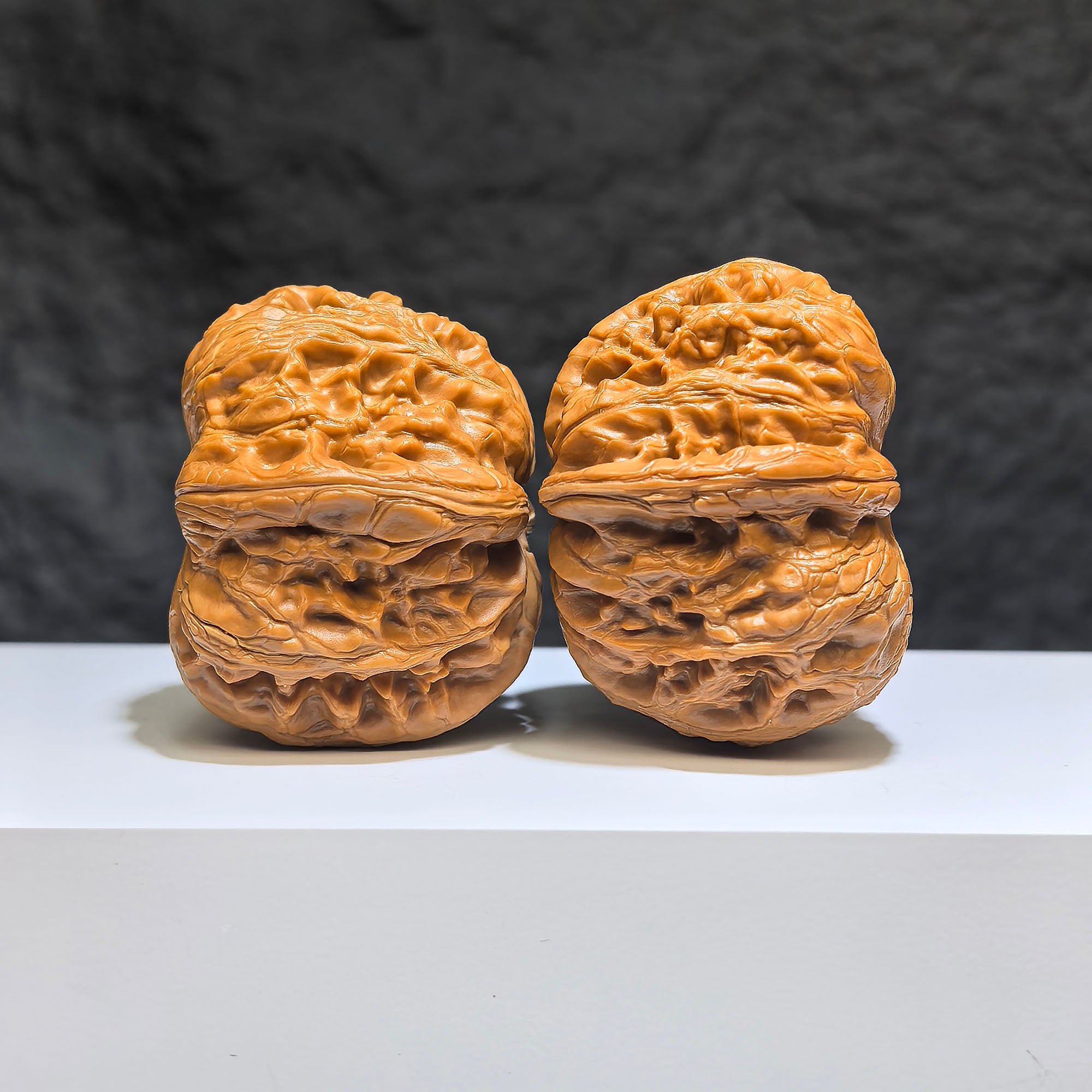 Pair of Pinggu Sycee Yuanbao-shaped Wenwan walnuts from Wenwan Art, 39mm by 46mm, featuring intricate carved details.
