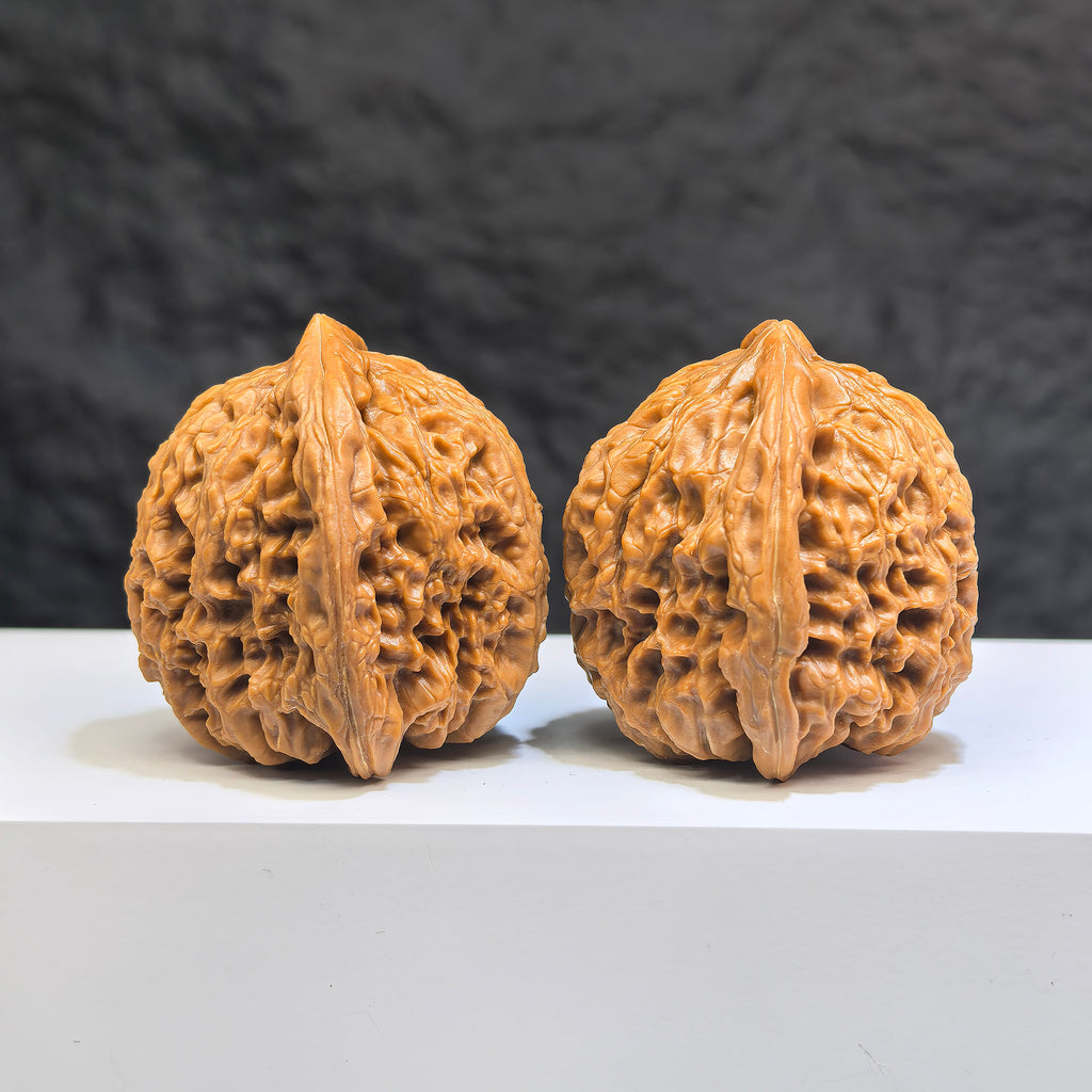 Pair of Nanjiangstone Wenwan walnuts from Wenwan Art, 38mm x 39mm, featuring intricate natural stone details.