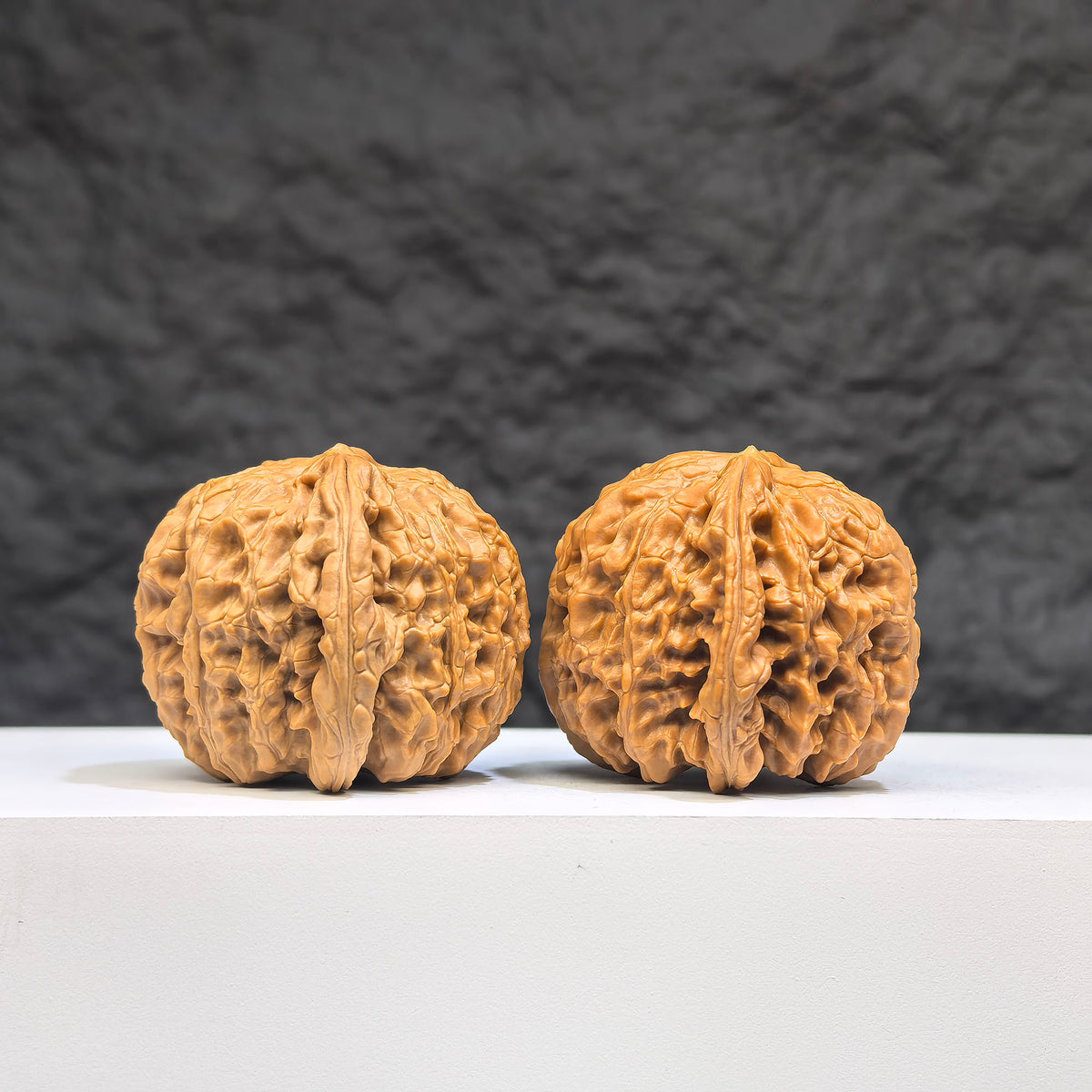 Pair of White Lion Wenwan Walnuts from Wenwan Art, 37mm x 38mm, featuring intricate carvings and smooth surfaces.