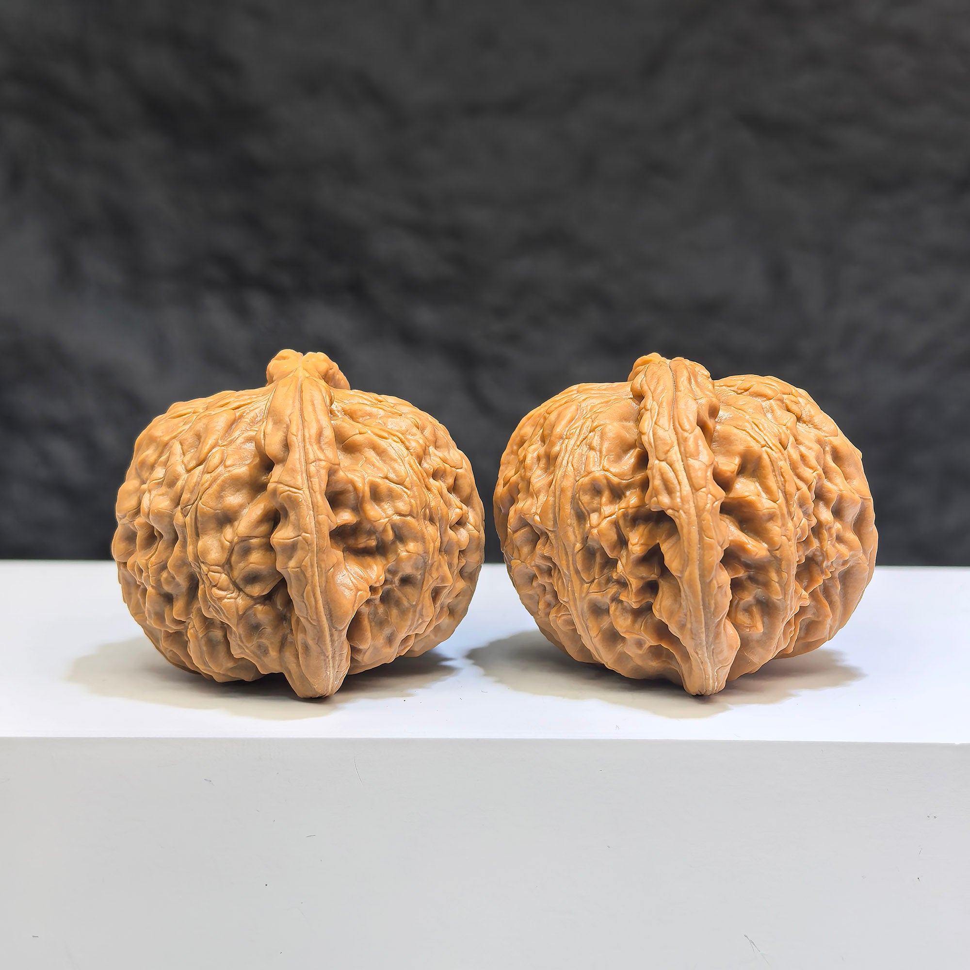 Pair of Low-pointed White Lion Wenwan walnuts from Wenwan Art, 41mm x 38mm, showcasing detailed carved white lion figures.