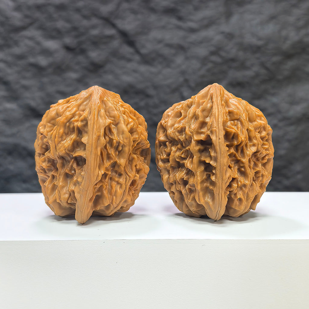 Pair of Beijing Chicken Heart Wenwan walnuts from Wenwan Art, featuring 43mm x 45mm polished walnuts with intricate natural patterns.