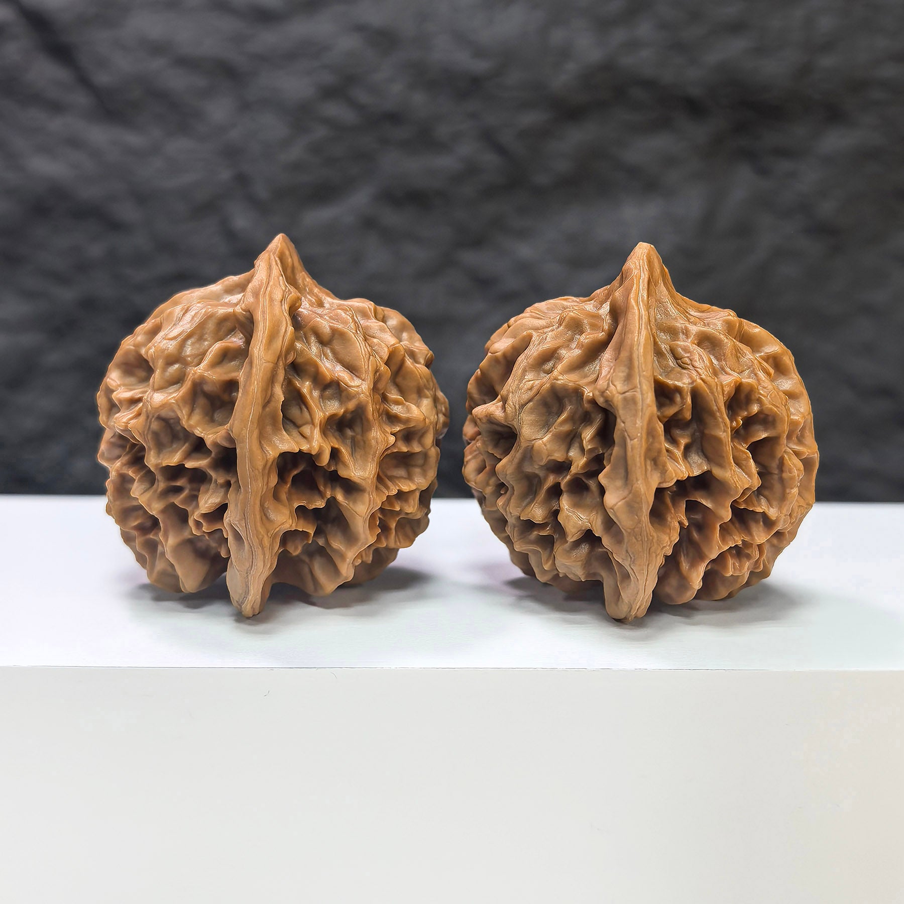Pair of Emperor Wenwan Walnuts from Wenwan Art, 43mm x 42mm, showcasing smooth, polished surfaces with natural wood grain details.