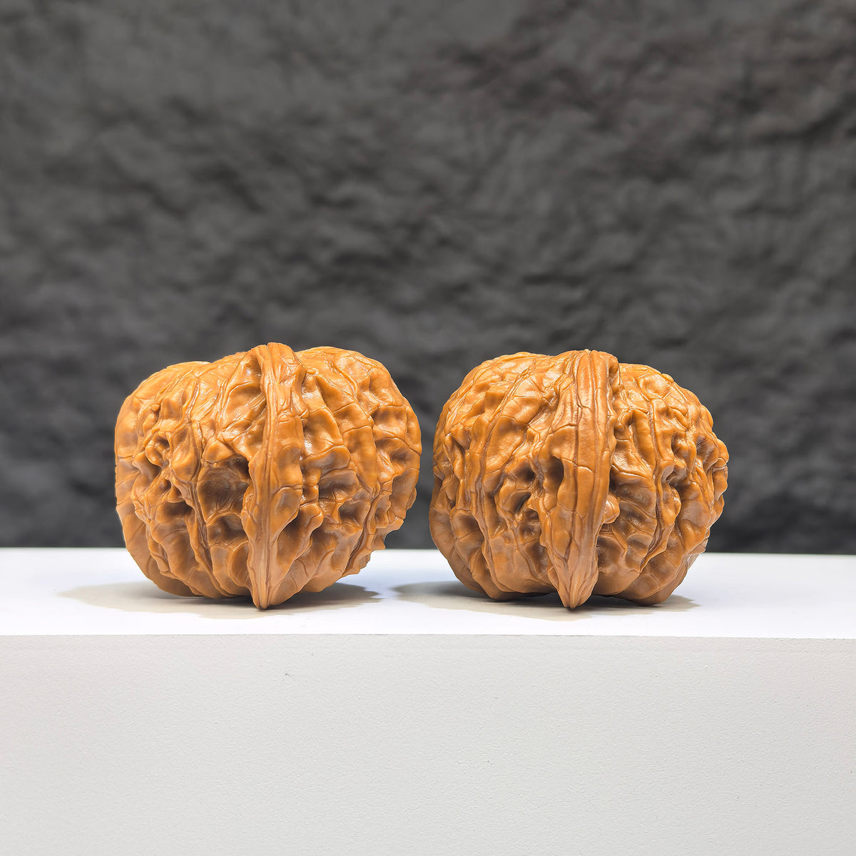 Pair of red shell Wenwan walnuts from Wenwan Art, classic 39mm x 38mm HKMB-1N9 millstone style with intricate red shell patterns.
