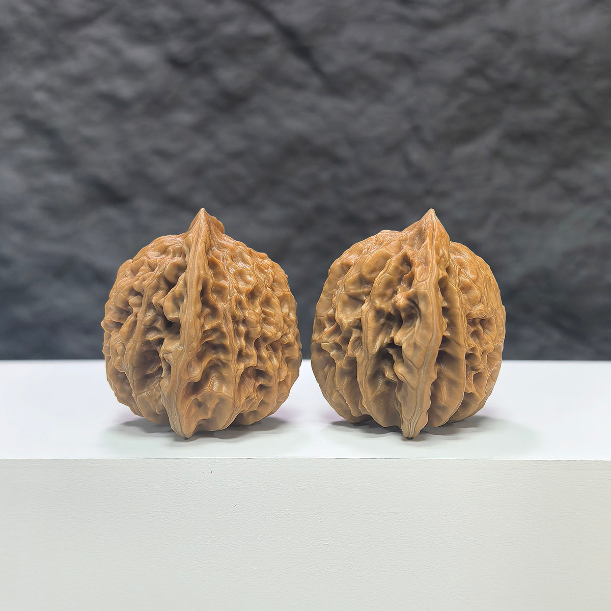 Pair of Peach Heart Xiayunling Wenwan walnuts by Wenwan Art, 38mm x 35mm, showcasing smooth, polished wood with natural grain details.