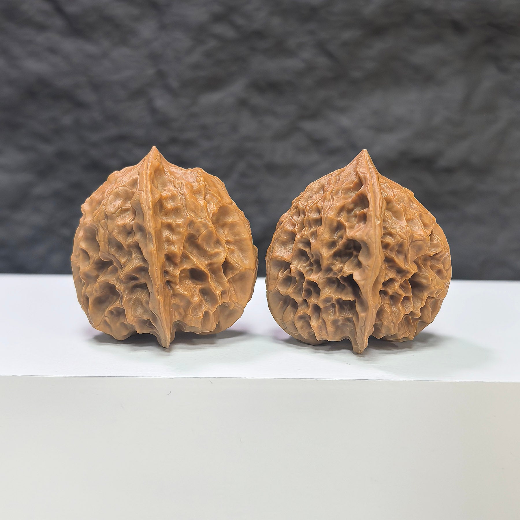 Pair of Linglong x White Snake Valley Wenwan walnuts by Wenwan Art, 33mm x 35mm, featuring intricate natural walnut textures.