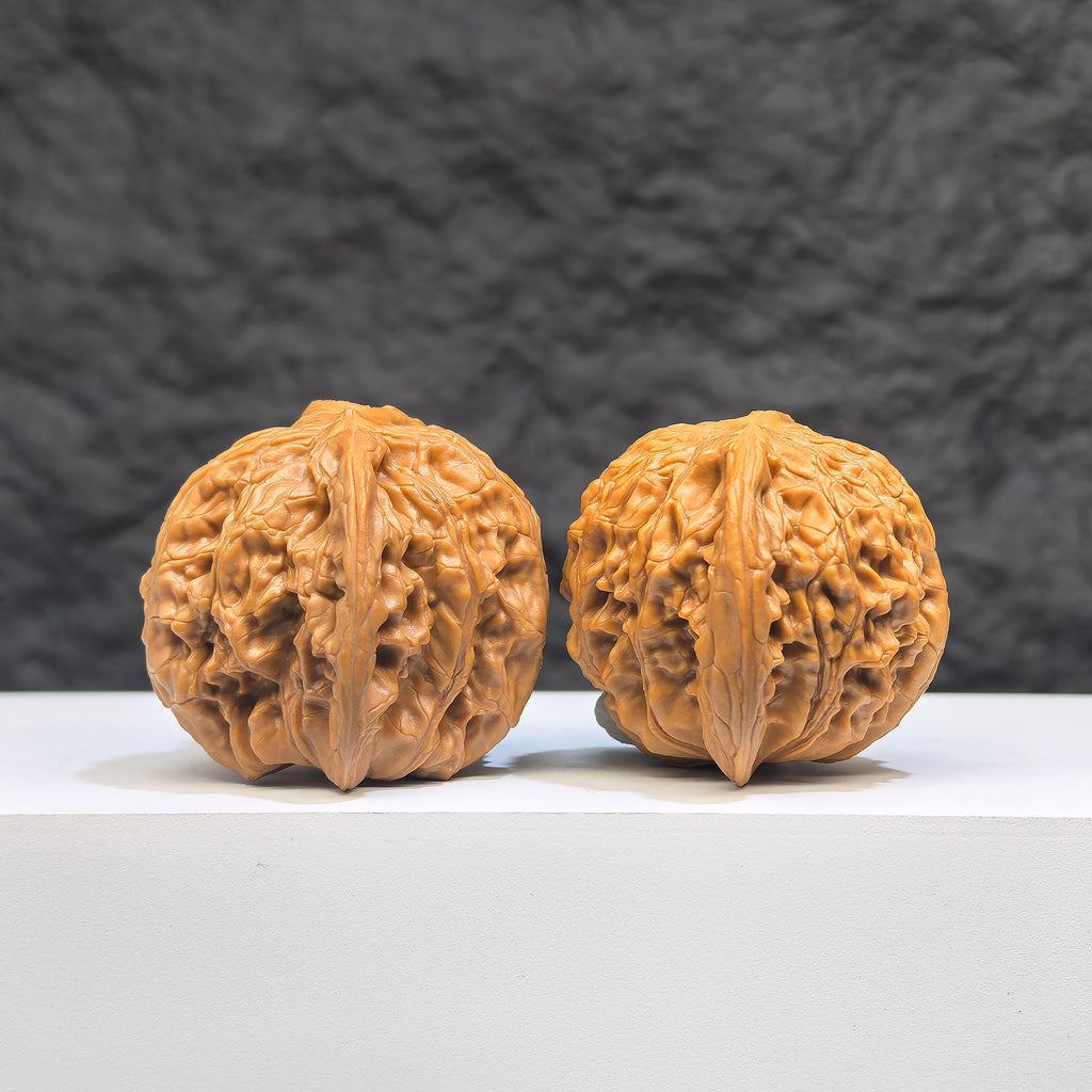 Pair of Butterfly Millstone Wenwan Walnuts by Wenwan Art, 38mm x 37mm, featuring intricate butterfly designs on smooth walnut surfaces.