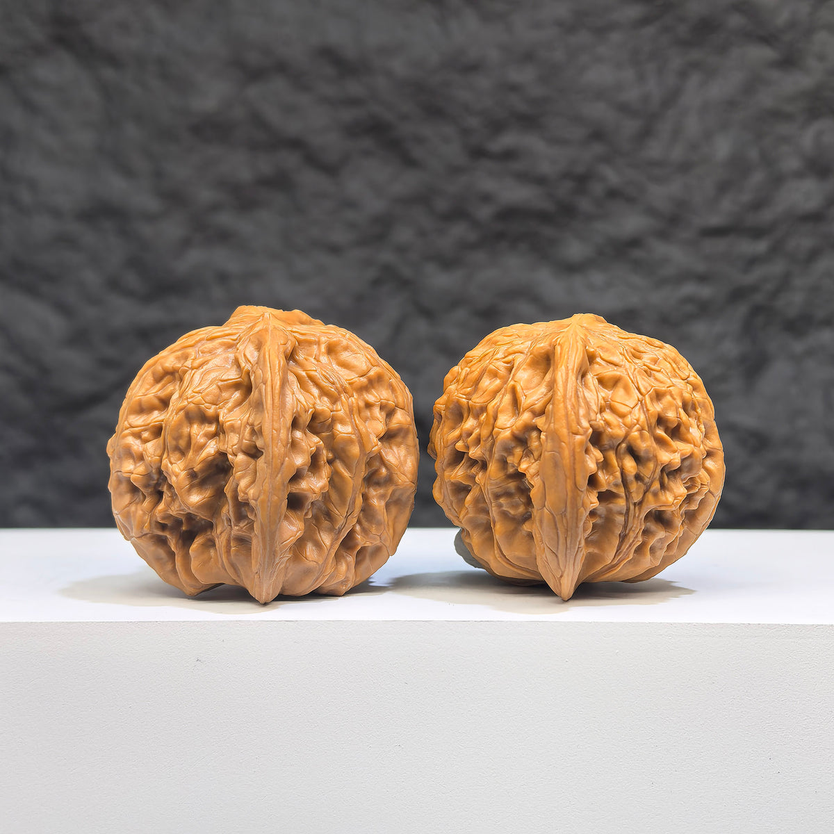 Pair of Butterfly Millstone Wenwan Walnuts by Wenwan Art, 38mm x 37mm, featuring intricate butterfly designs on smooth walnut surfaces.
