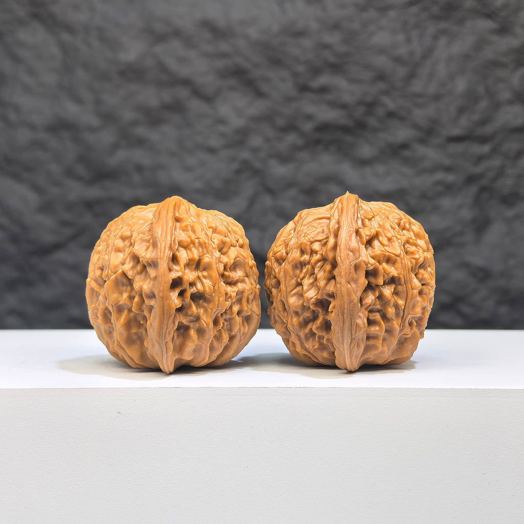 Pair of Wenwan Art Millstone Classic Wenwan Walnuts, 37mm x 34mm, featuring detailed engravings and smooth polished surfaces.