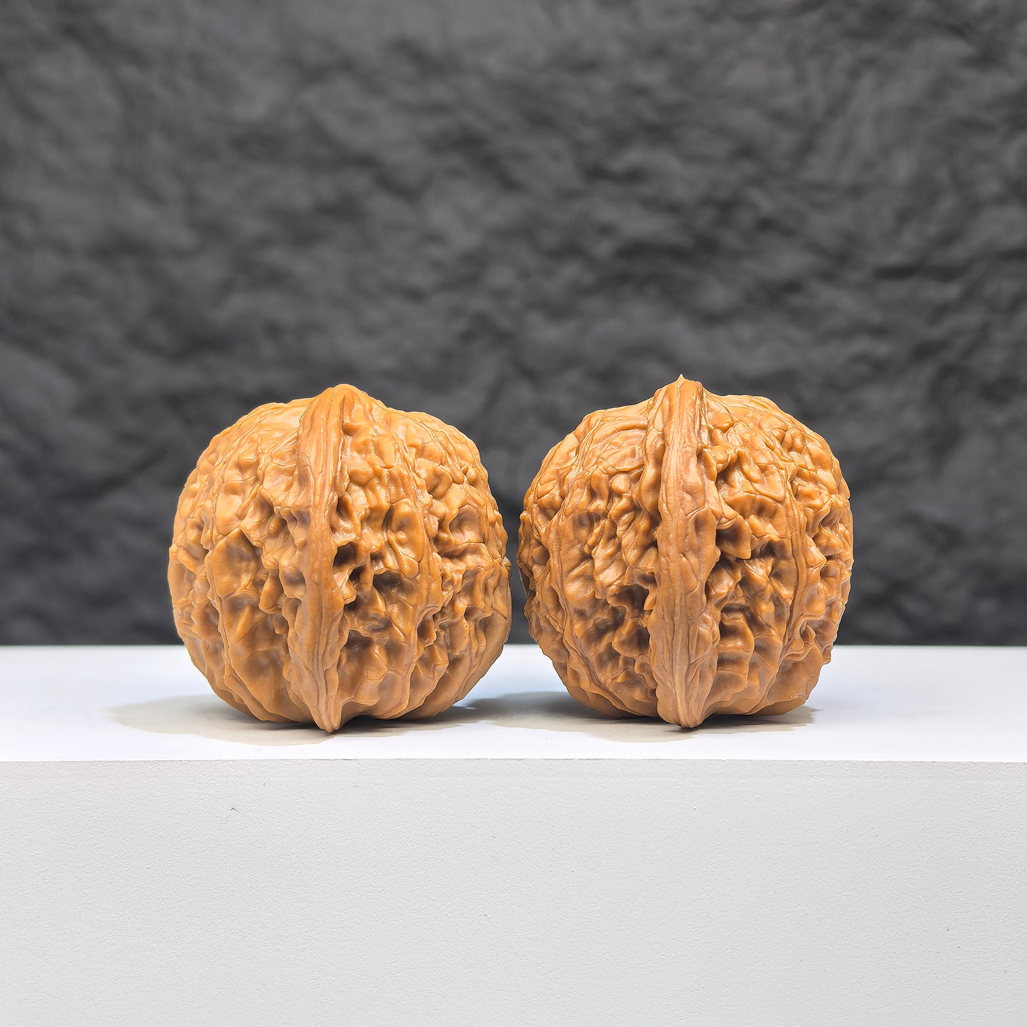 Pair of Wenwan Art Millstone Classic Wenwan Walnuts, 37mm x 34mm, featuring detailed engravings and smooth polished surfaces.