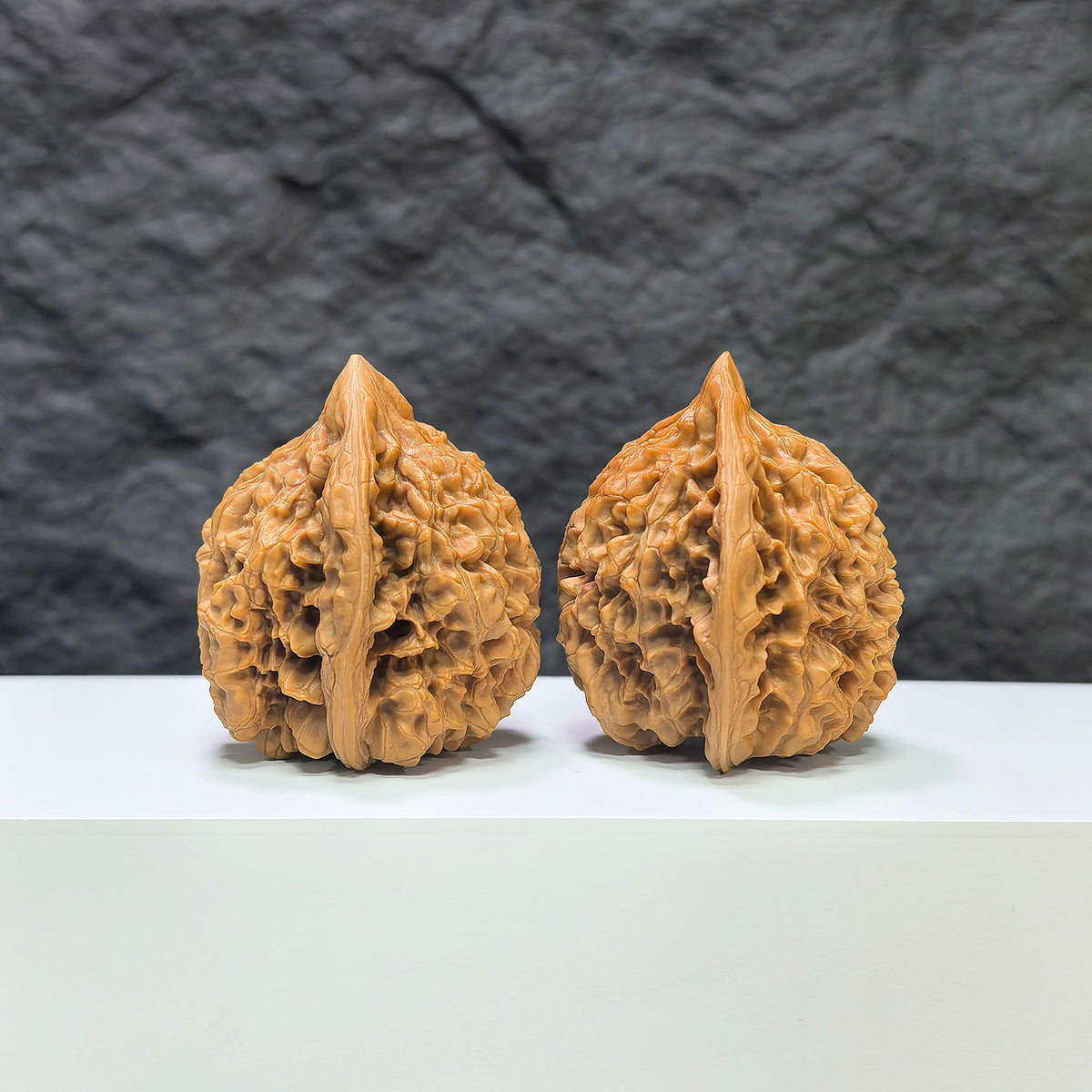 Pair of large Wenwan Art official Wenwan walnuts, 45mm x 41mm, with smooth, polished surfaces and detailed natural wood grain.