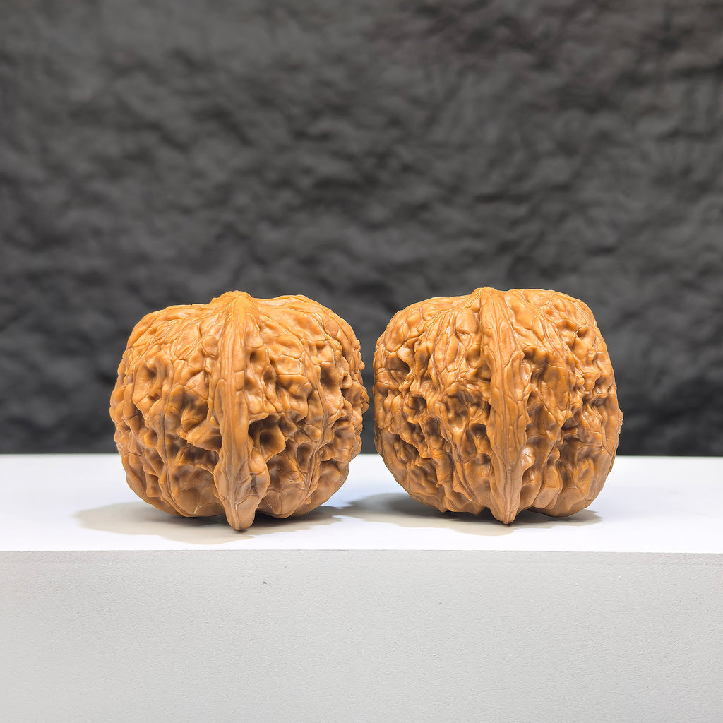 Pair of Wild Millstone Wenwan Walnuts from Wenwan Art, 36mm, showcasing natural wood grain and unique organic shapes.