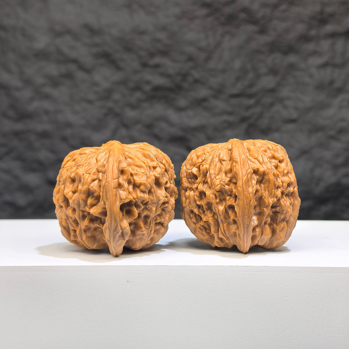 Pair of Wild Millstone Wenwan Walnuts from Wenwan Art, 36mm, showcasing natural wood grain and unique organic shapes.
