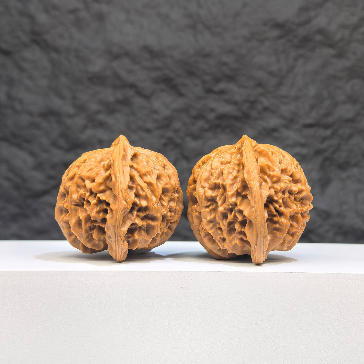 Pair of Peach Heart Palace Lantern Wenwan walnuts by Wenwan Art, 42mm x 38mm, featuring intricate peach heart carvings.