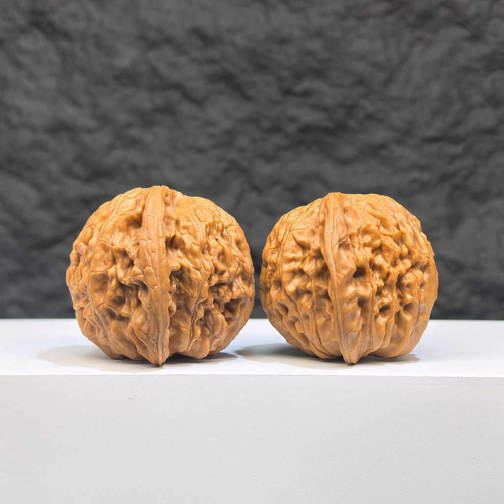 Pair of Butterfly Millstone Wenwan walnuts by Wenwan Art, featuring detailed butterfly and millstone carvings, 38mm x 37mm.
