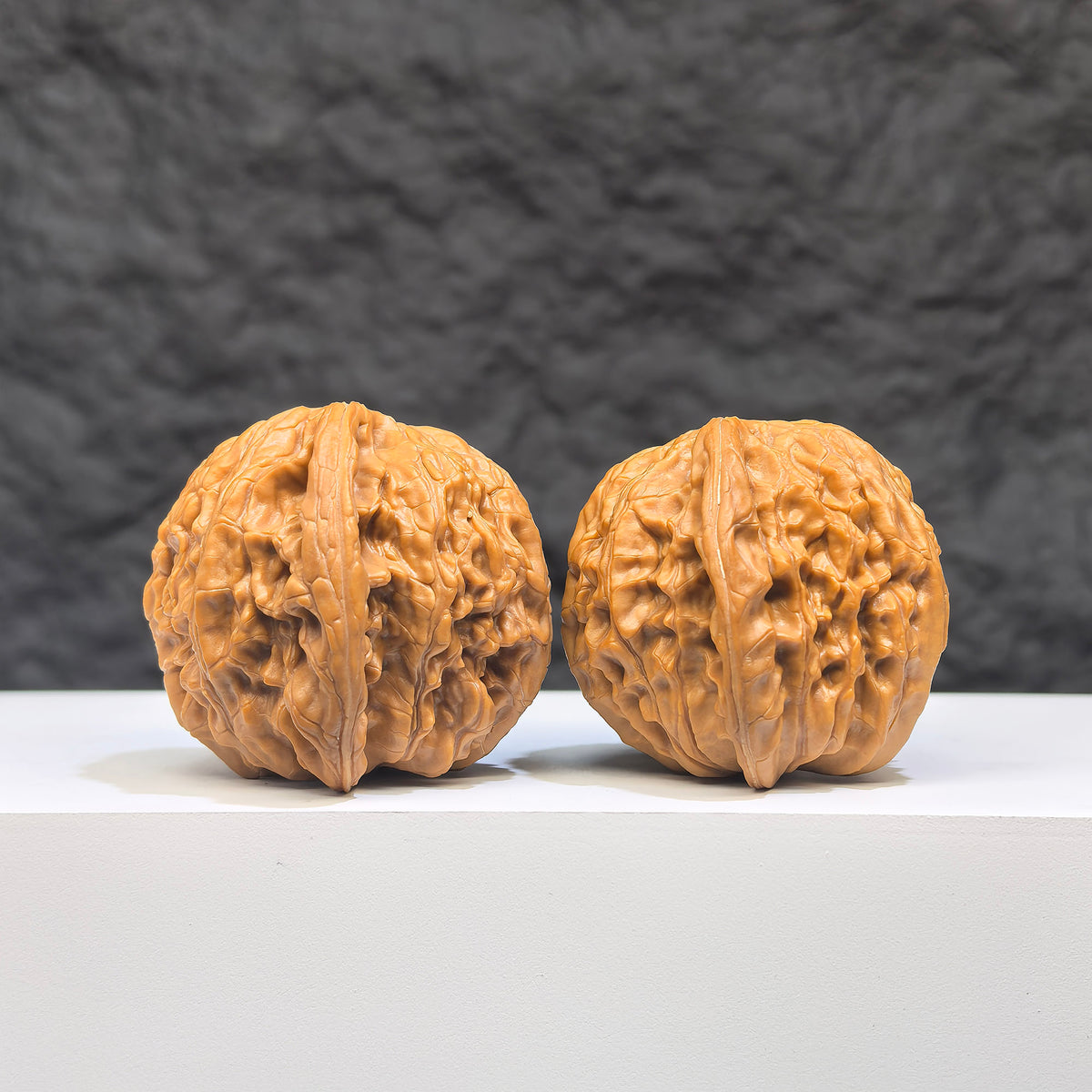 Pair of Butterfly Millstone Wenwan walnuts by Wenwan Art, featuring detailed butterfly and millstone carvings, 38mm x 37mm.