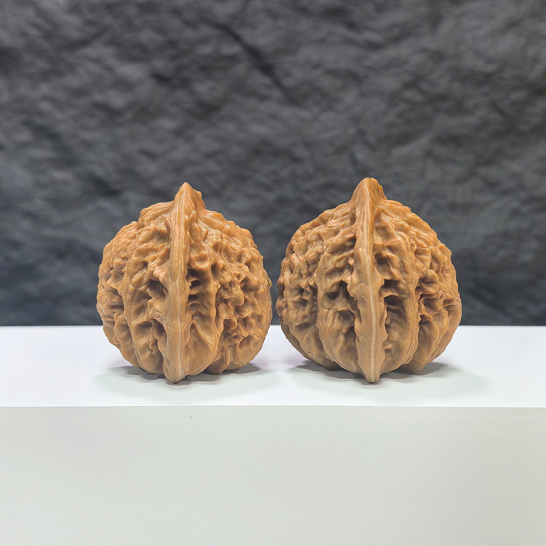 Pair of Xiayunling Classic Wenwan walnuts from Wenwan Art, featuring smooth brown surfaces and intricate natural patterns.