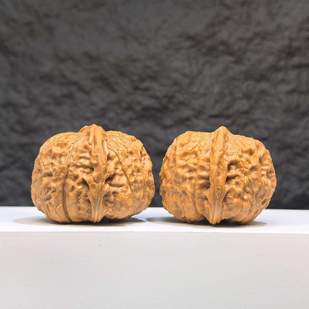 Pair of Pumpkin Pier Wenwan Walnuts by Wenwan Art, 41mm x 44mm, showcasing detailed carved pumpkin designs.