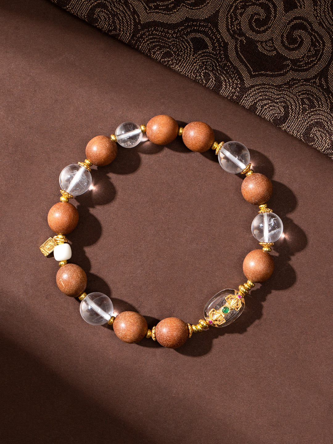 Beads bracelet featuring sandalwood and clear quartz vajra beads, 10mm, with natural wood and transparent quartz details.