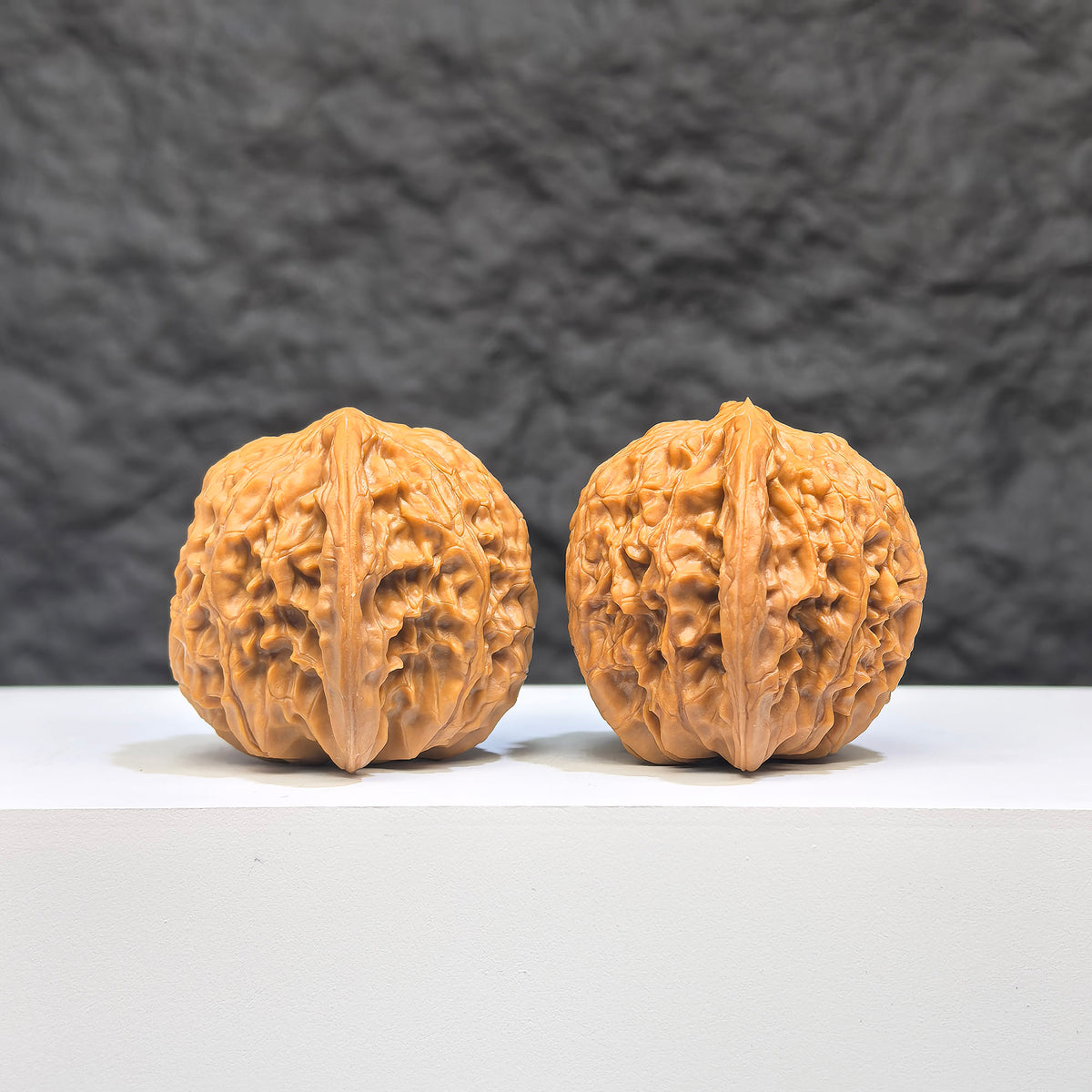 Pair of Wenwan Art Millstone Classic Wenwan walnuts, 37mm x 34mm, showing detailed carved patterns and natural walnut textures.