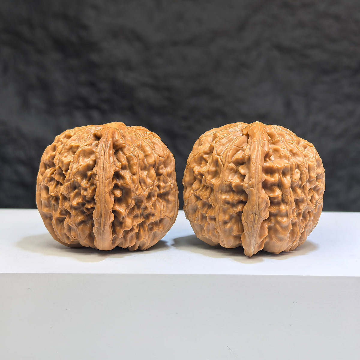 Pair of White Lion Wenwan Walnuts by Wenwan Art, 38mm x 39mm, featuring detailed carvings and natural walnut texture.
