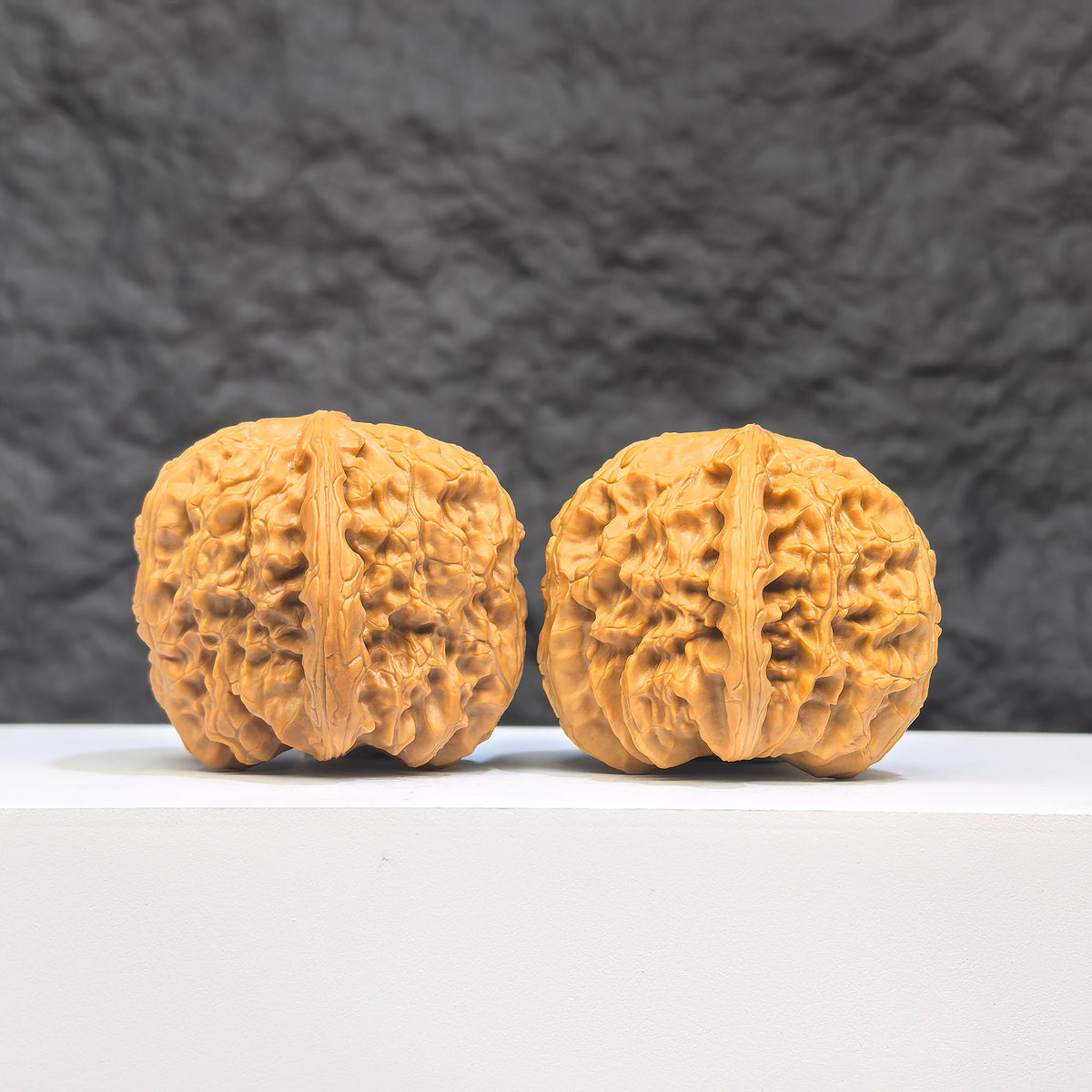Pair of White Lion Wenwan Walnuts by Wenwan Art, 36mm x 39mm, featuring detailed carvings on smooth white walnut surfaces.