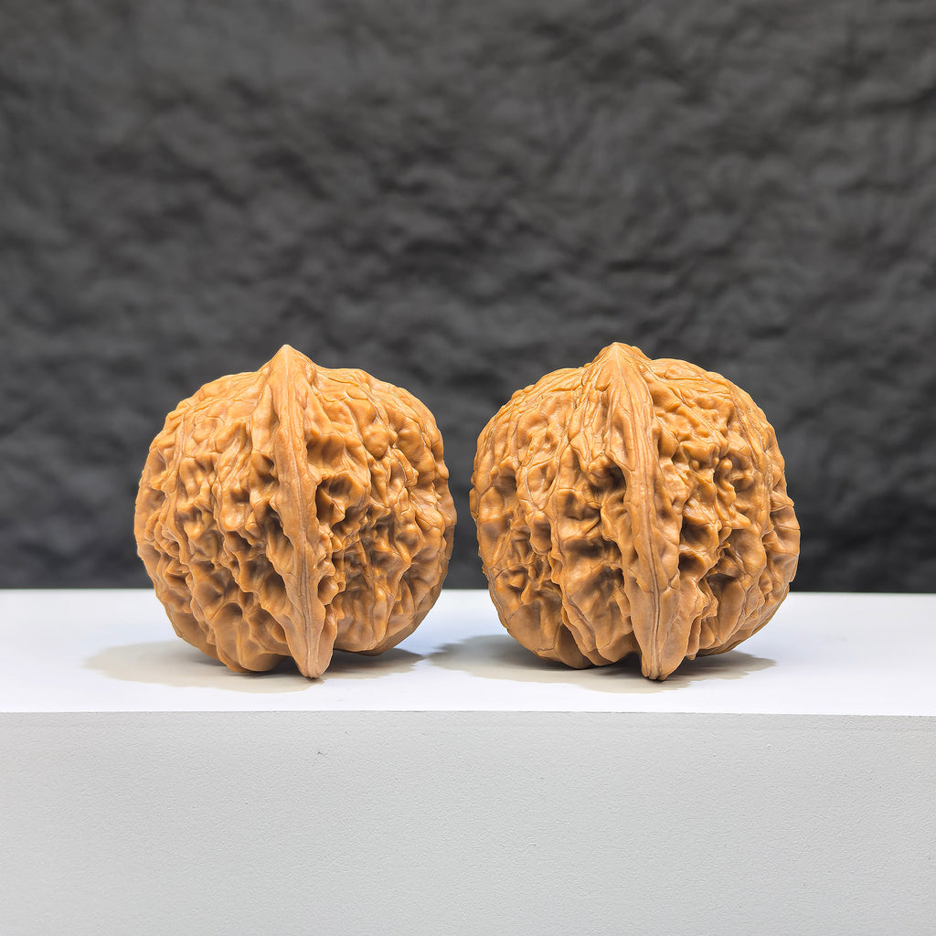 Pair of Wenwan Art Millstone Classic Wenwan walnuts, 38mm x 37mm, showing detailed carved patterns and smooth polished surfaces.