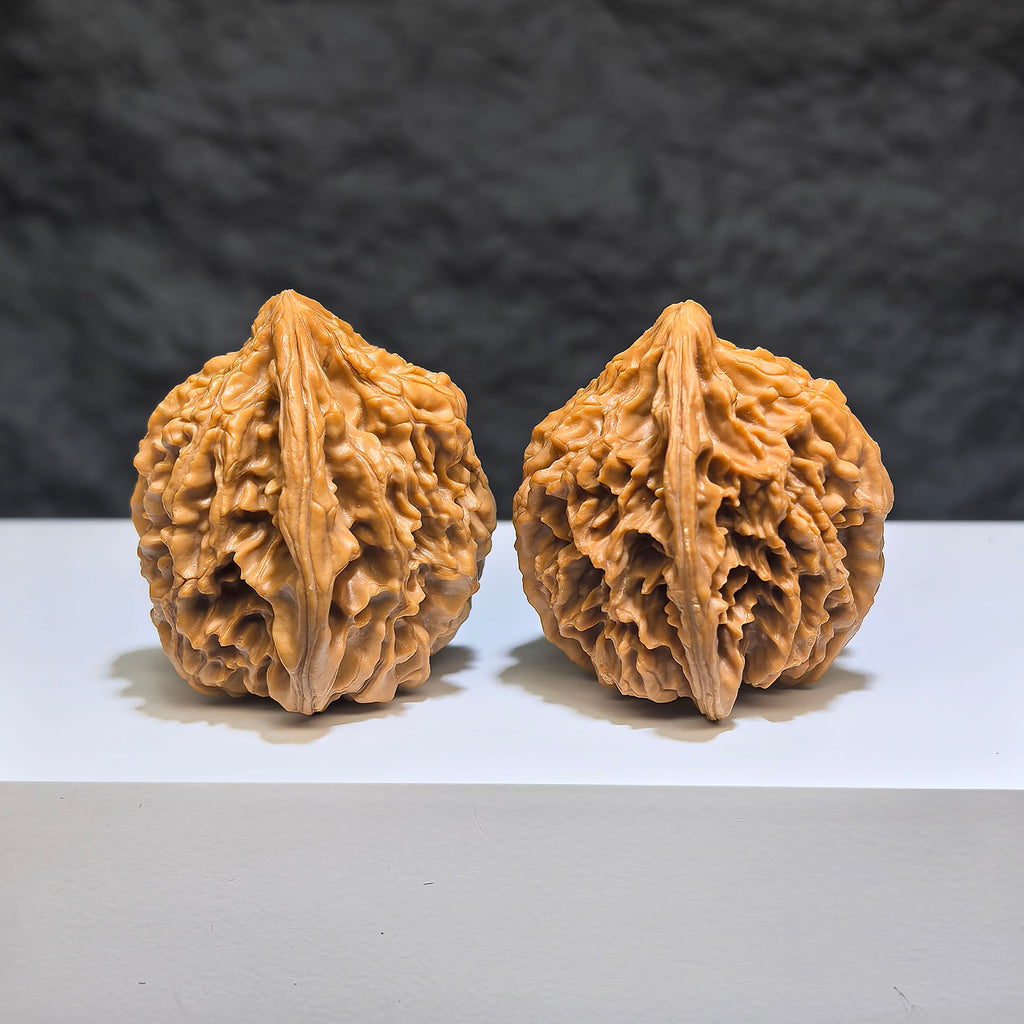 Pair of Tongtian Eight Classic Wenwan walnuts from Wenwan Art, 36mm x 35mm, showcasing polished walnut carvings.