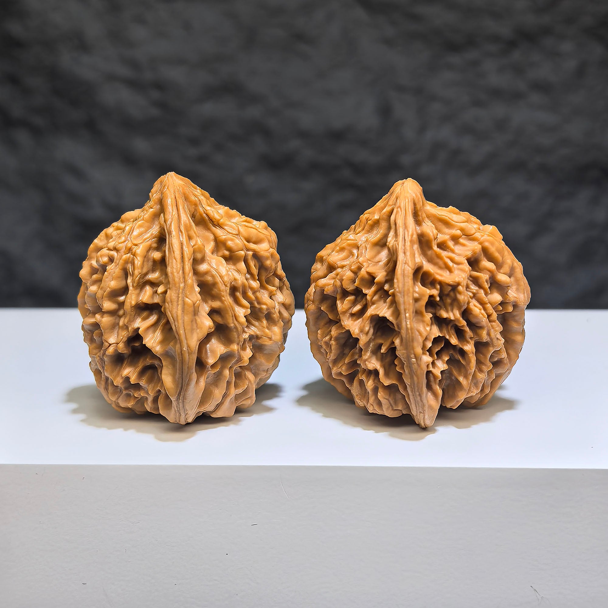 Pair of Tongtian Eight Classic Wenwan walnuts from Wenwan Art, 36mm x 35mm, showcasing polished walnut carvings.