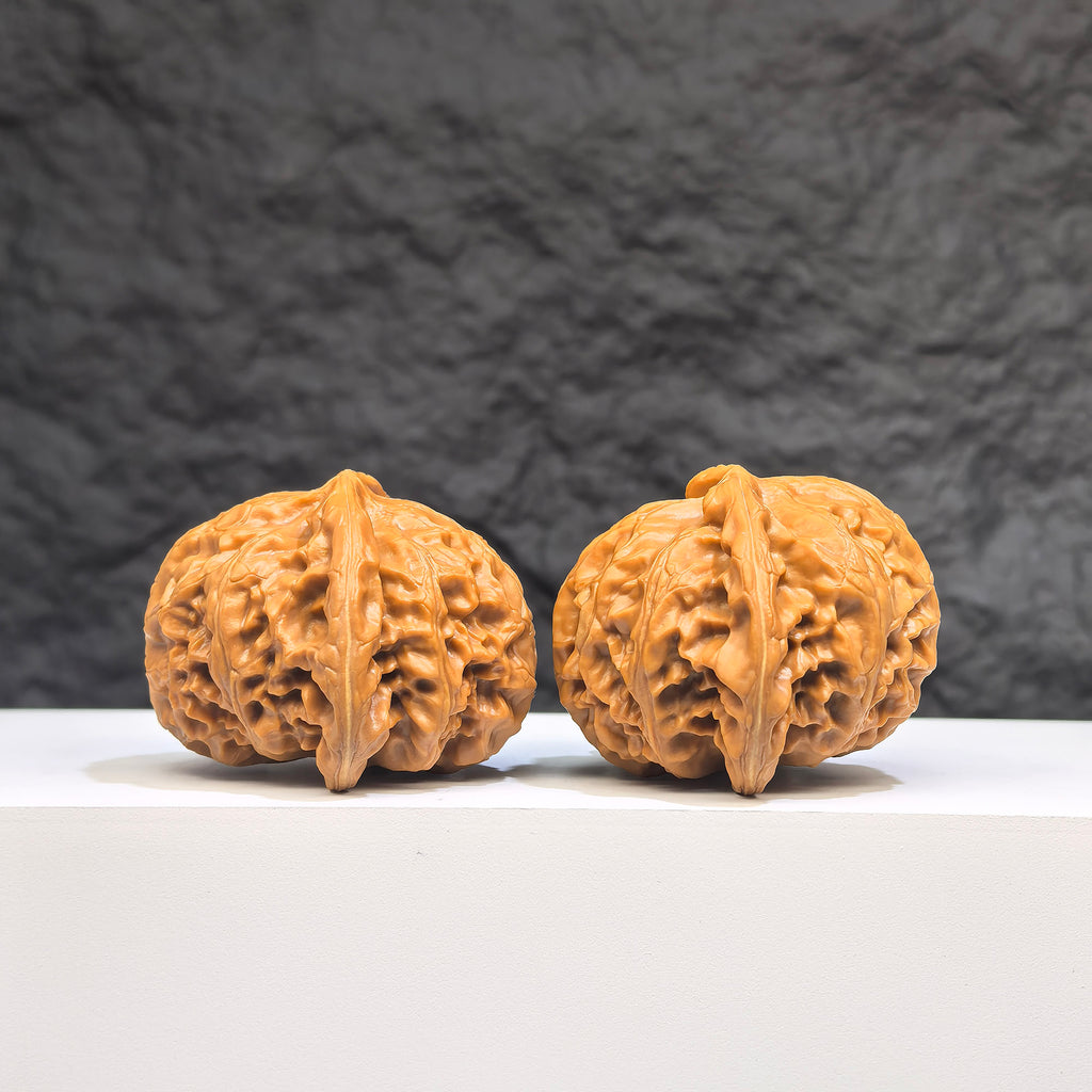 Pair of Palace Lantern Wenwan Walnuts by Wenwan Art, 42mm x 41mm, featuring intricate carved designs on smooth walnut surfaces.