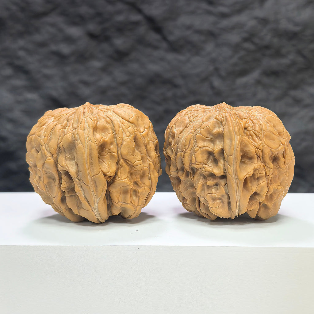 Pair of Wenwan Art Classic Scholar hand-matched Wenwan walnuts, 44mm x 46mm, showcasing detailed craftsmanship and natural walnut texture.