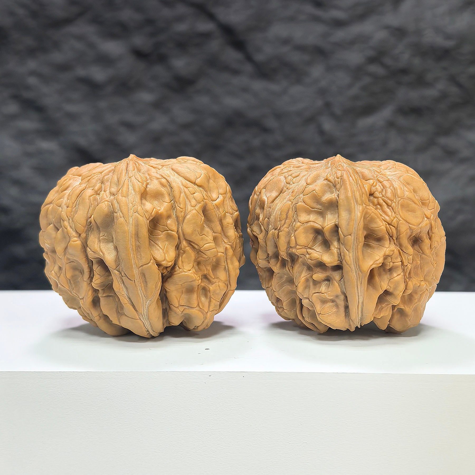 Pair of Wenwan Art Classic Scholar hand-matched Wenwan walnuts, 44mm x 46mm, showcasing detailed craftsmanship and natural walnut texture.