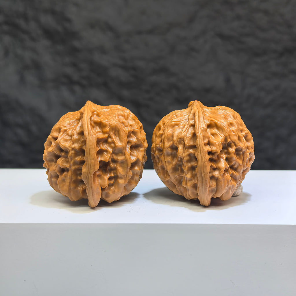 Pair of Wild Wolf Yelang Deep-Carved Wenwan Walnuts from Wenwan Art, showcasing intricate carvings and natural walnut texture.