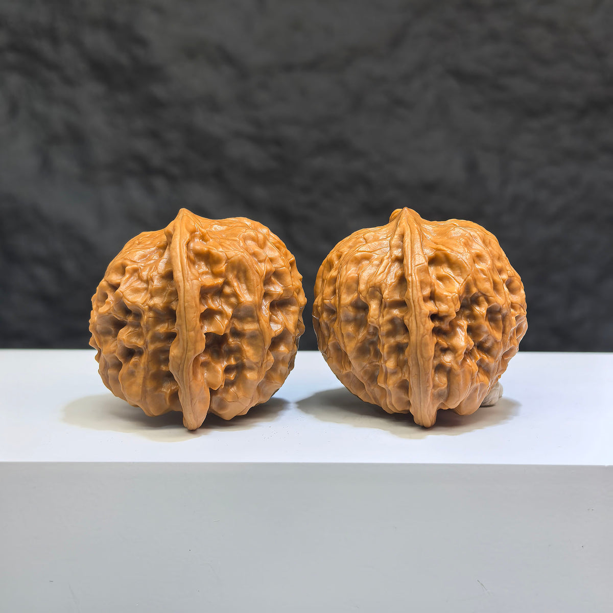 Pair of Wild Wolf Yelang Deep-Carved Wenwan Walnuts from Wenwan Art, showcasing intricate carvings and natural walnut texture.