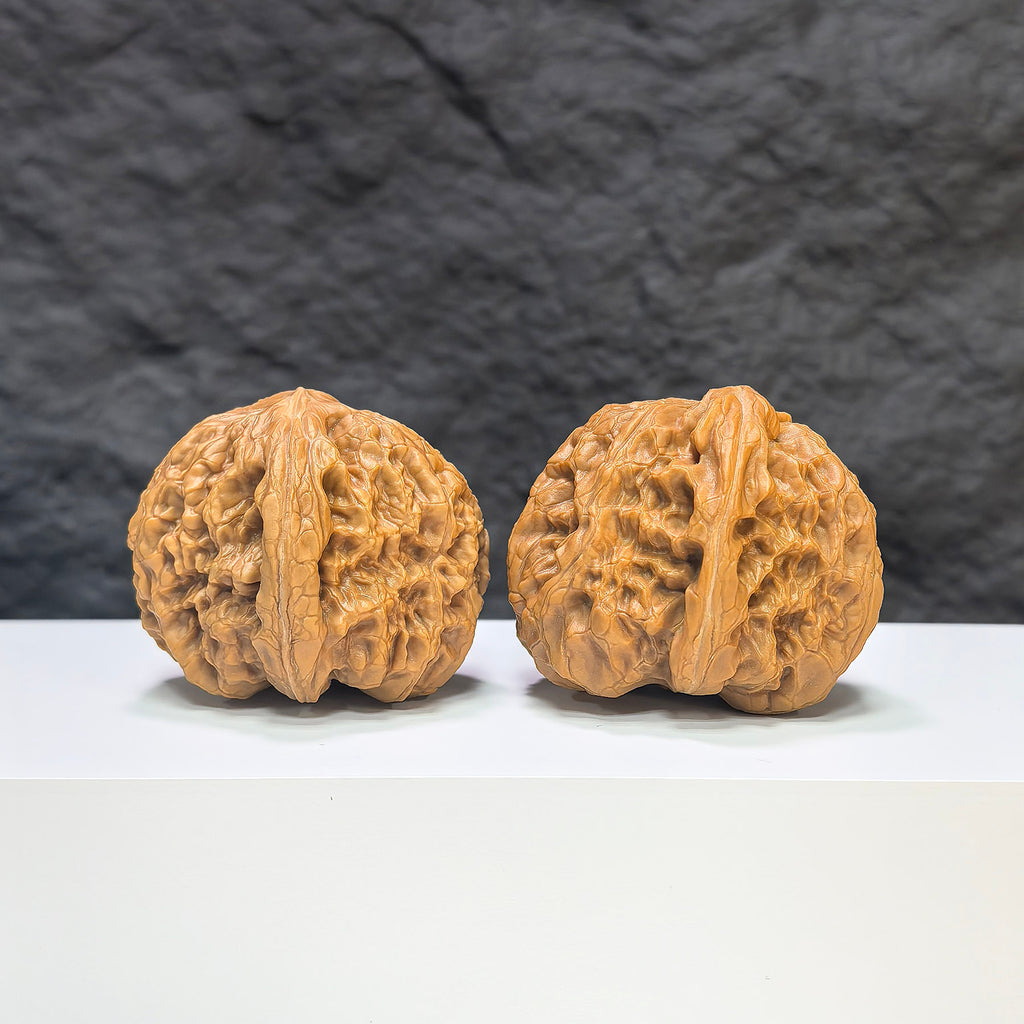 Pair of classic Wenwan Walnuts from Wenwan Art, 40mm diameter, featuring intricate rolling donkey design on smooth walnut surfaces.