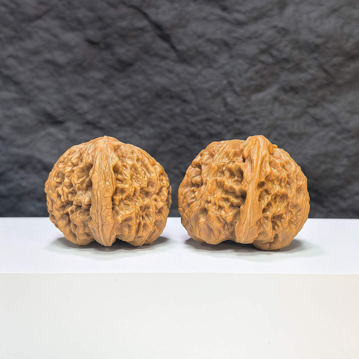 Pair of classic Wenwan Walnuts from Wenwan Art, 40mm diameter, featuring intricate rolling donkey design on smooth walnut surfaces.