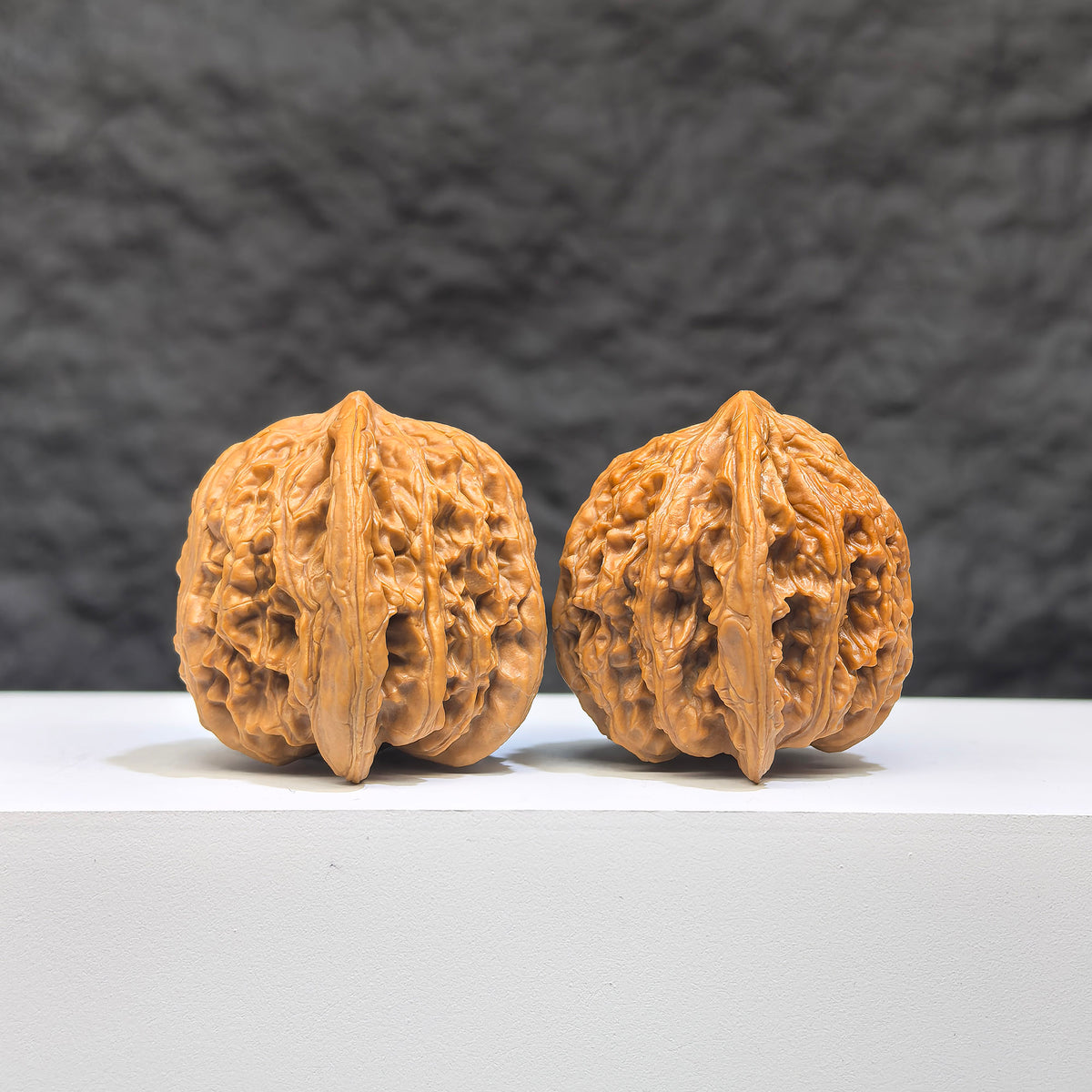 Pair of Peach Heart Concave Base Ruby Wenwan Walnuts from Wenwan Art, 35mm x 33mm, showcasing deep-base red walnut carvings.