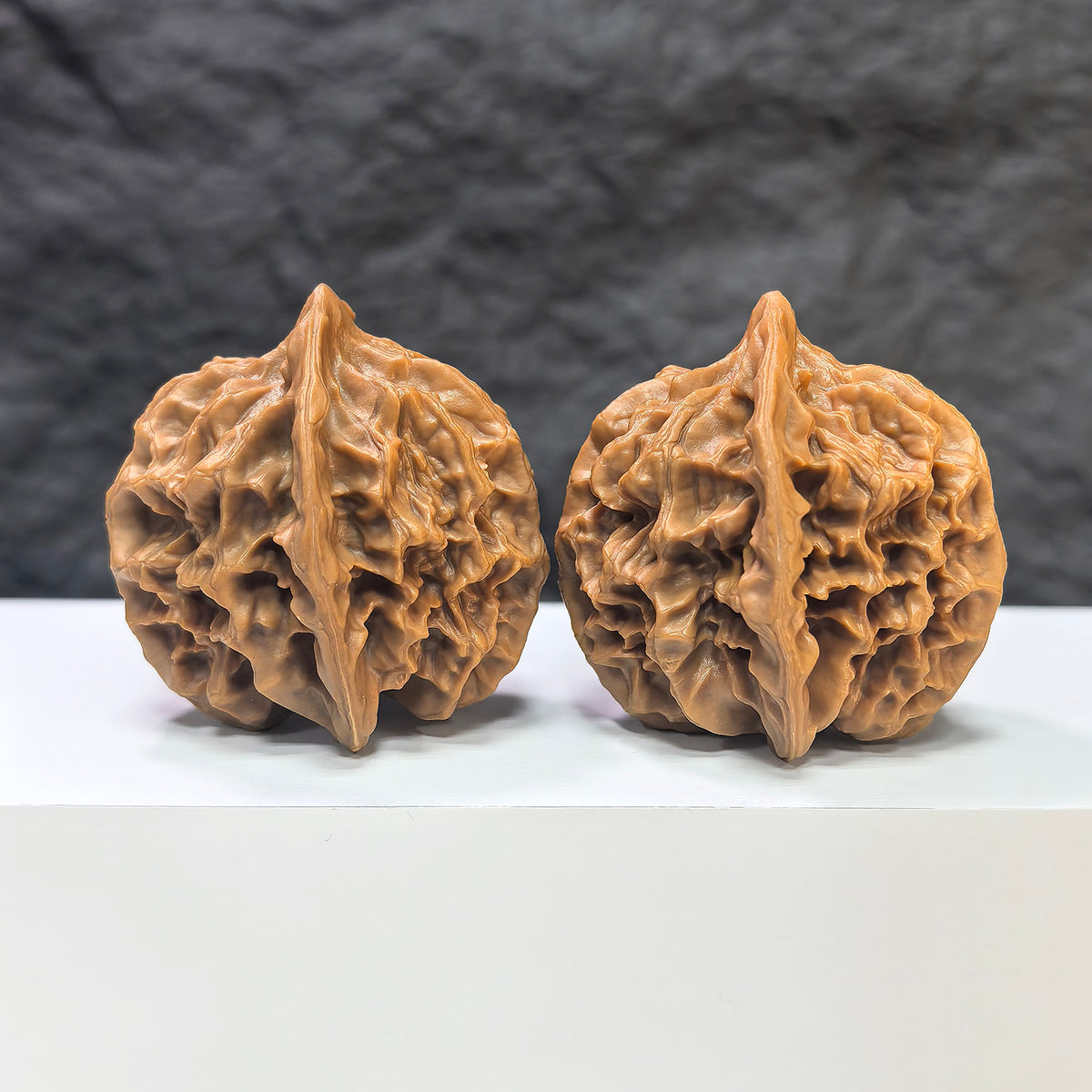 Pair of "Emperor" Wenwan walnuts from Wenwan Art, 43mm x 42mm, showing smooth, polished walnut carvings with intricate details.