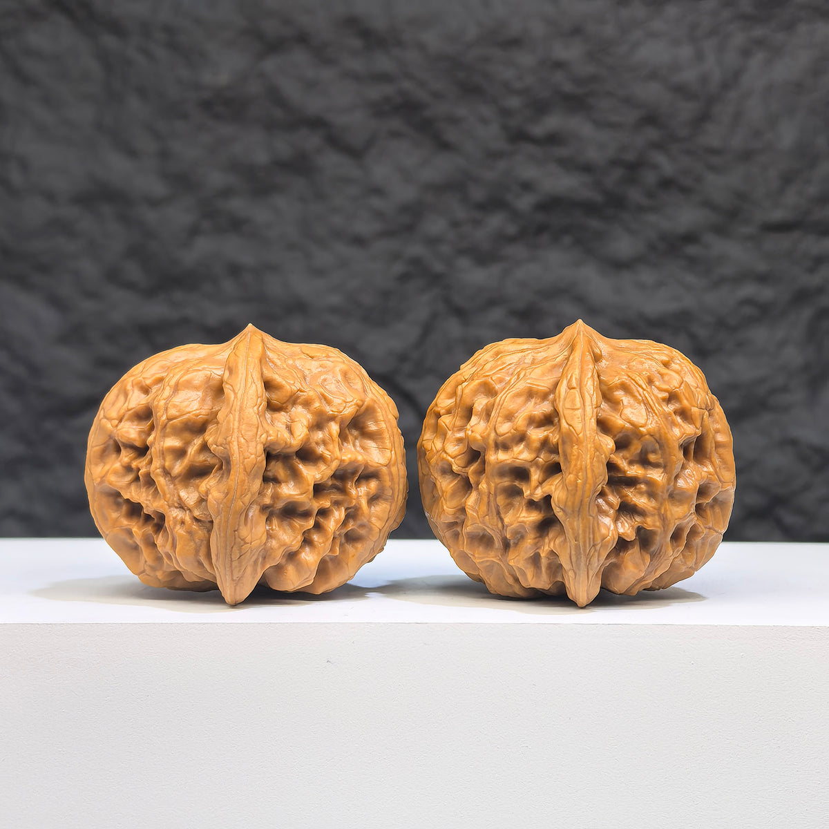 Pair of authentic Wild Wolf Wenwan walnuts from Wenwan Art, 37mm x 39mm, featuring natural wood grain and unique textures.