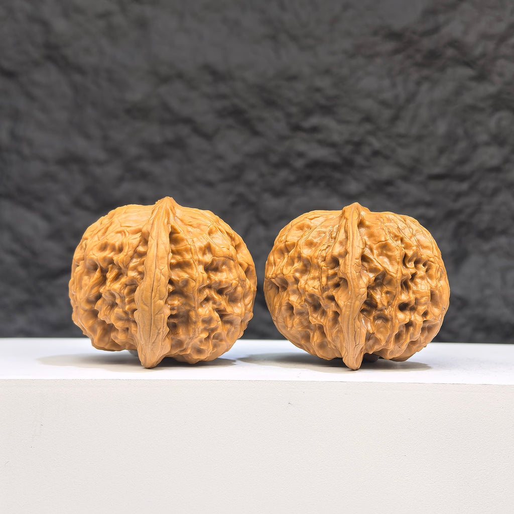 Pair of authentic Wild Wolf Wenwan walnuts from Wenwan Art, 38mm x 40mm, showcasing natural wood grain and unique patterns.