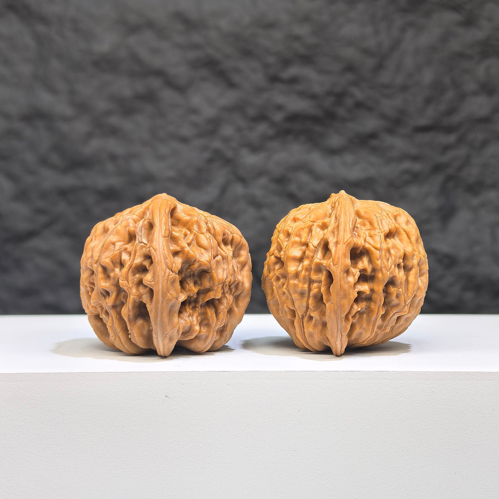 Miniature Wenwan Walnut pair with symmetrical millstone design from Wenwan Art, measuring 36mm x 33mm, showcasing detailed craftsmanship.